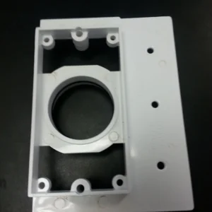 A white plastic box with holes for mounting.