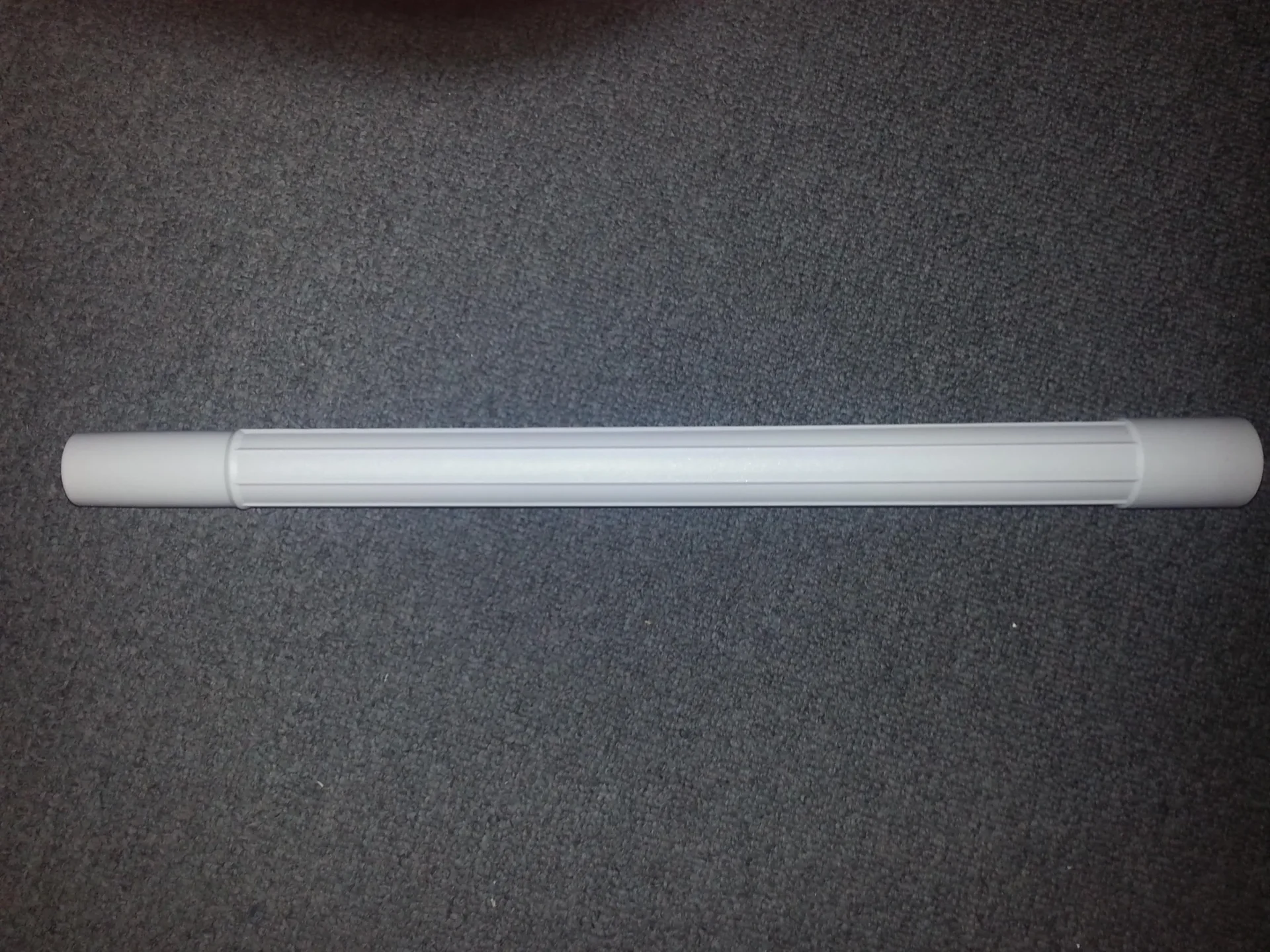 A white tube is sitting on the floor.