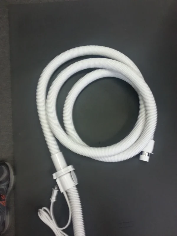 A white hose is connected to the end of a tube.