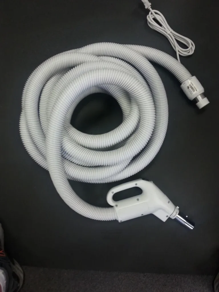 A white hose with a gas pump handle attached to it.