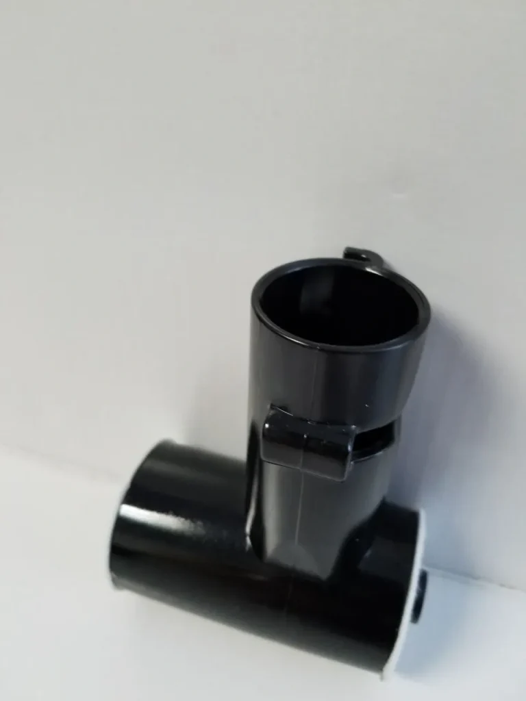 A black pipe sitting on top of the wall.
