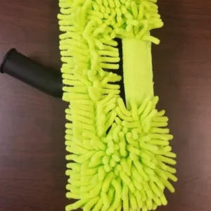 A yellow mop on top of a wooden table.