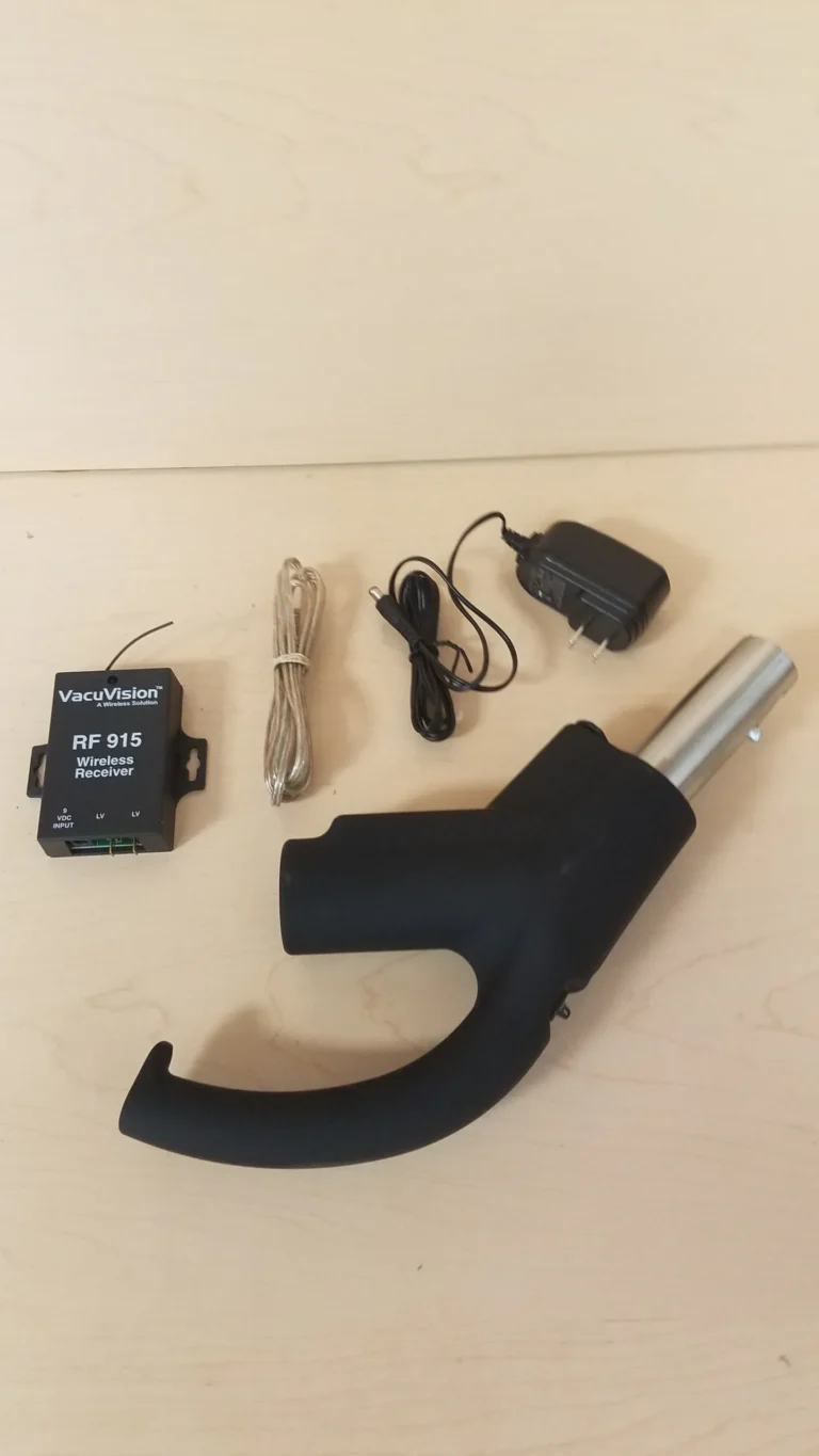 A black device with wires and a charger.