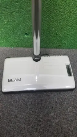 A beam vacuum cleaner on the floor of an office.