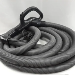 A hose with a black handle is laying on the floor.