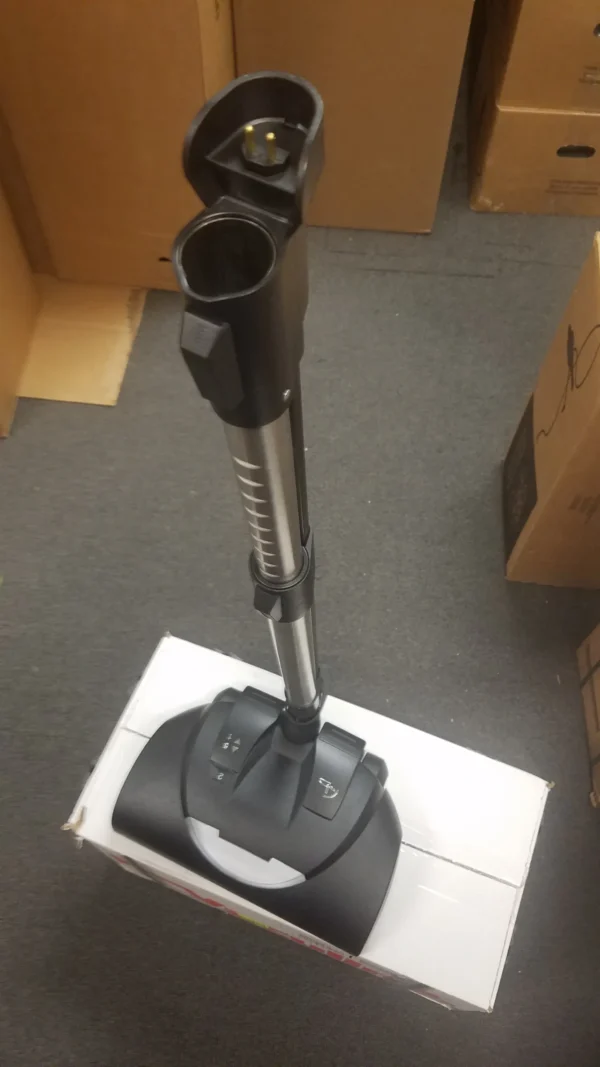 A black and silver vacuum cleaner on top of a floor.