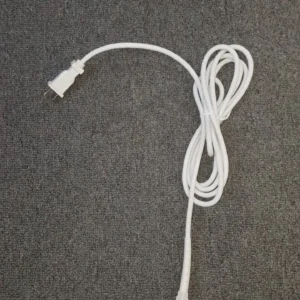 A white cord is laying on the floor.