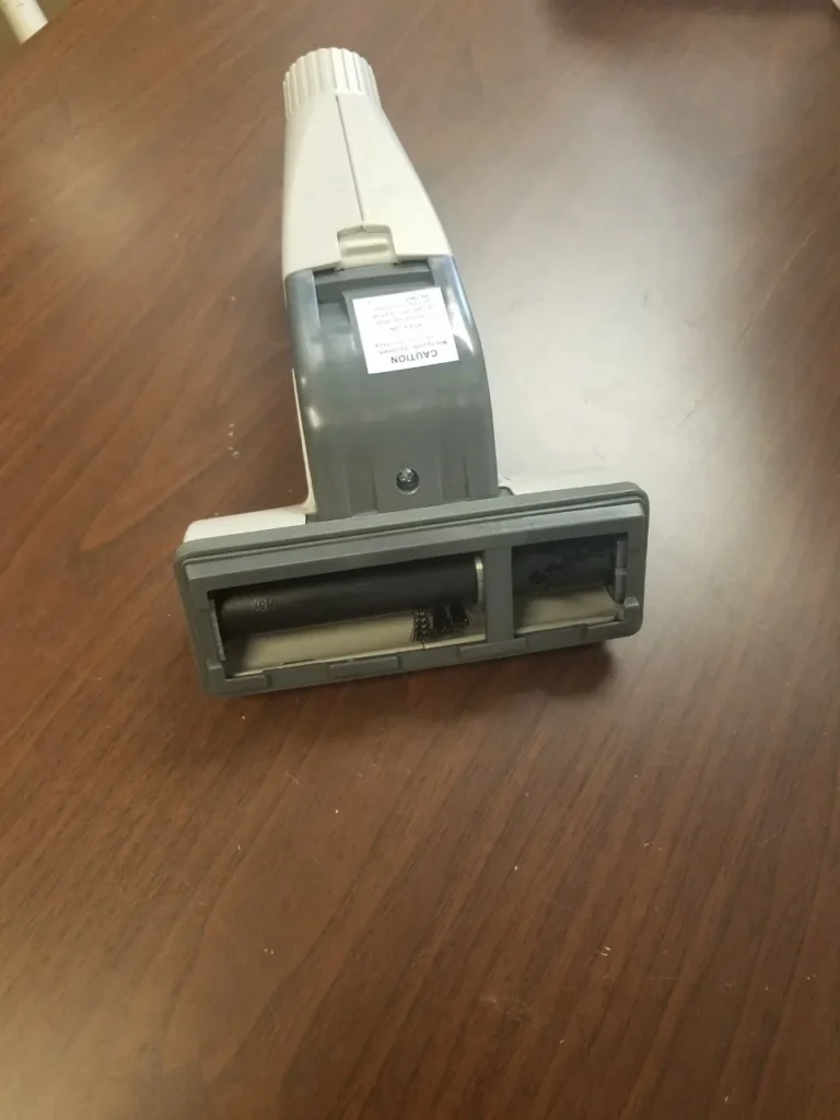 A close up of the handle on a vacuum cleaner