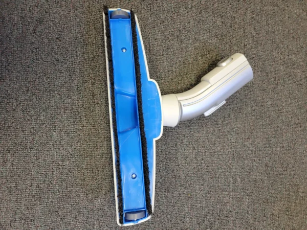 A blue and white vacuum head on the floor.