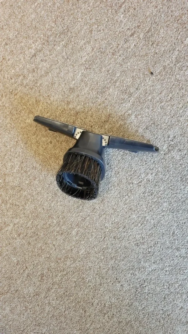 A hair dryer sitting on the floor.