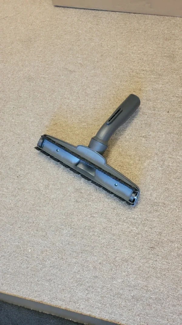 A close up of the handle on a vacuum cleaner