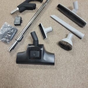 A carpet cleaning tool kit is laying on the floor.