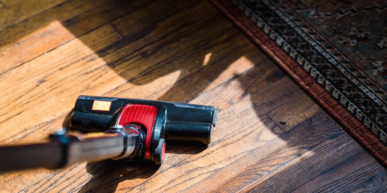 A black and red vacuum cleaner on the floor